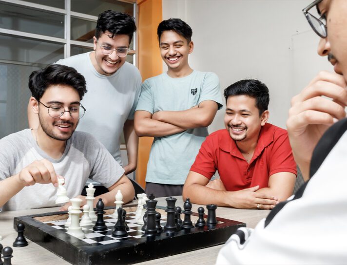 A dedicated development team playing chess in an office
